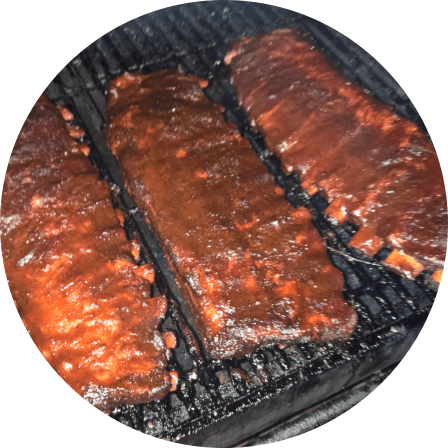 3 Racks of Ribs on a Smoker Grill